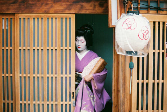 Traditional geisha exiting a tea house in Japan